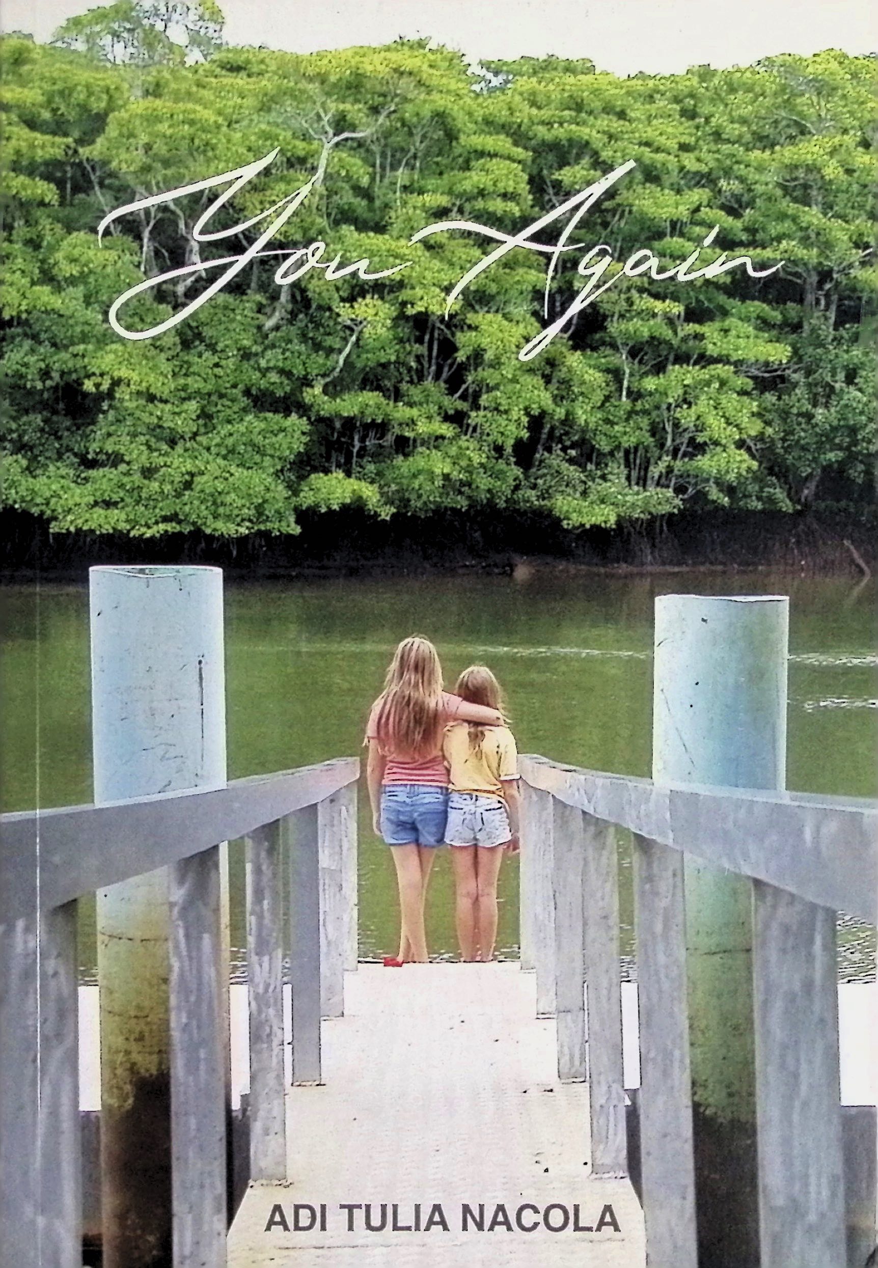 Two girls standing on the edge of a pier